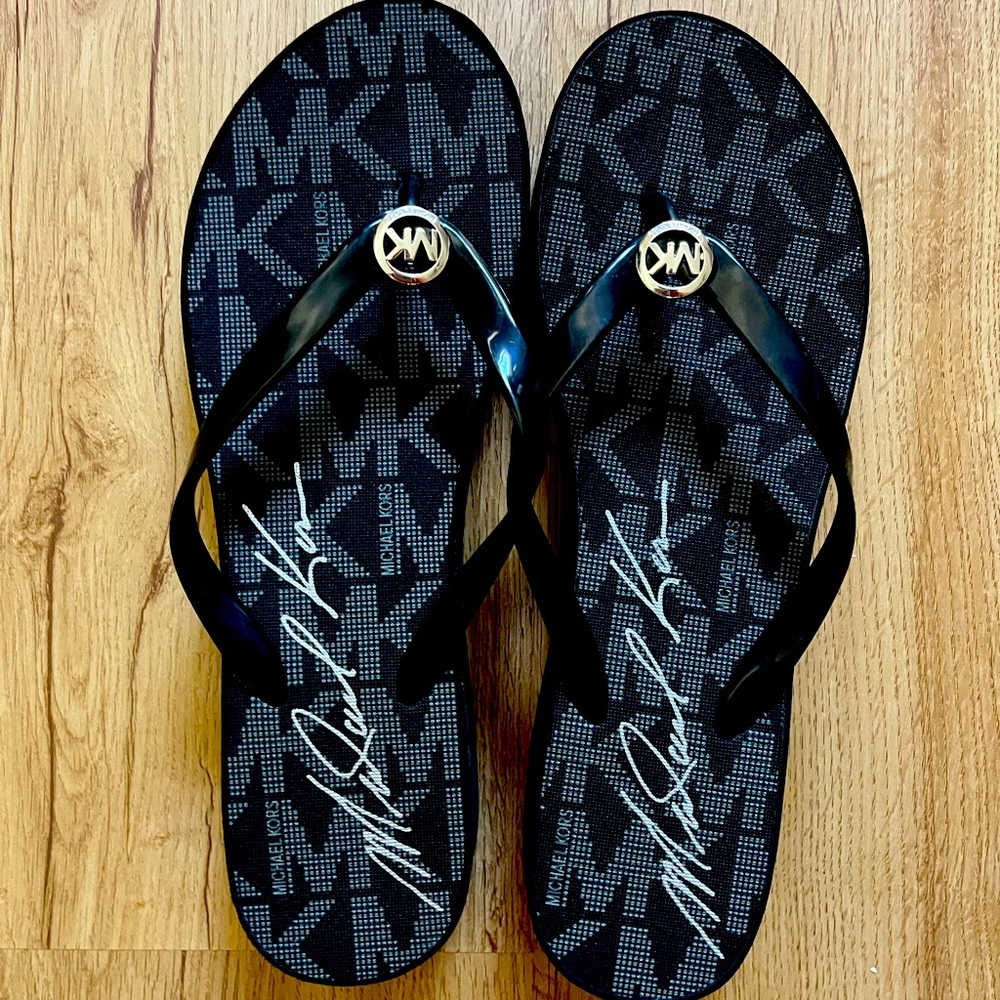 Black and grey MK flip flops